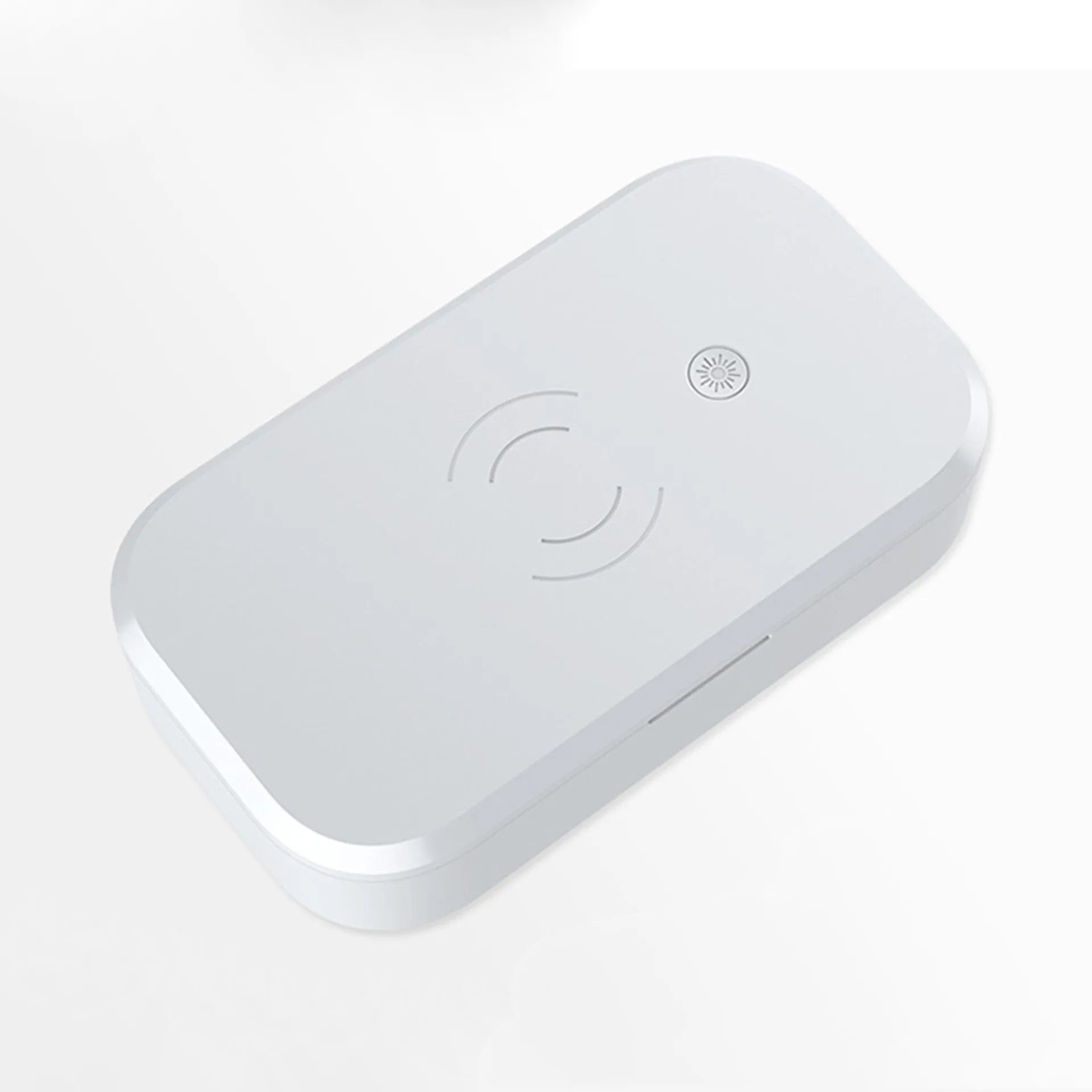 White ultraviolet disinfection box with wireless phone charging pad for nail and beauty tools.