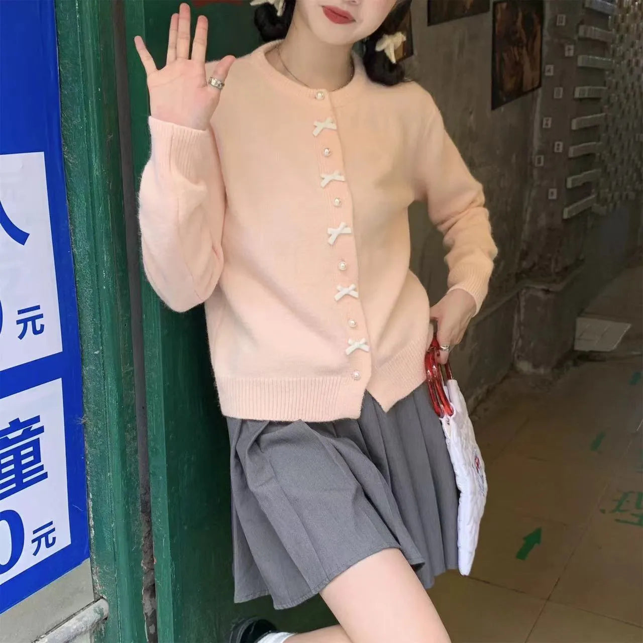 Women's acrylic cardigan with bow detail and pearl button in solid colour
