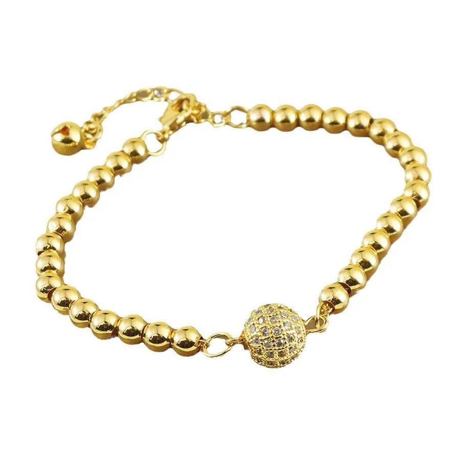 Close-up of a women's copper heart bracelet with a round zircon stone in an Arabic style.