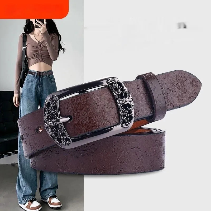 Thin black PU leather women's belt with an alloy buckle on a pair of jeans