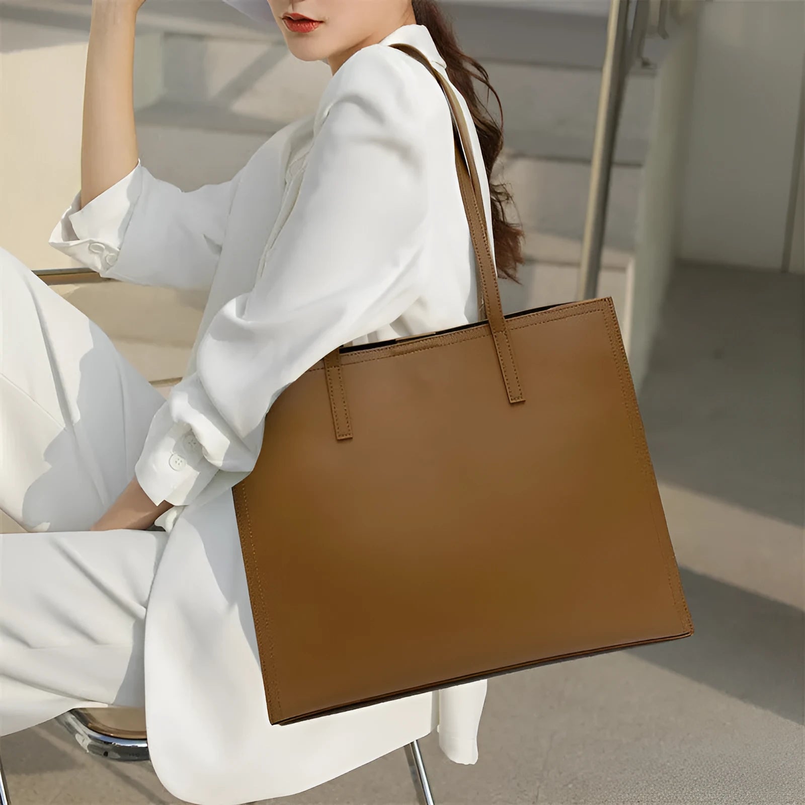 Brown genuine leather women's handbag with single shoulder strap and horizontal square shape