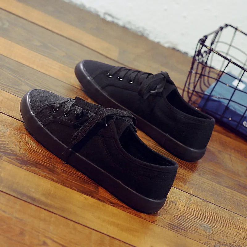 All-black women's canvas lace-up work shoes with flat rubber soles