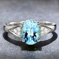 A women's court style ring with a natural zircon stone in a heart, water drop, or bell pattern, shown in blue, red, green, or light blue.