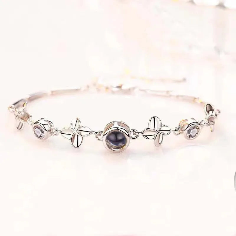 Women's sterling silver projection photo bracelet with white leaf and flower design and diamond-cut finish