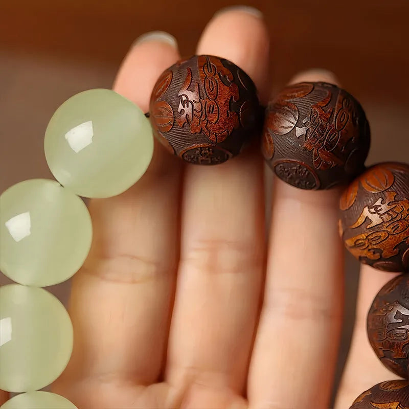 Rosewood flexible bracelet with fu character carving showing 12 wooden pieces connected by flexible cord