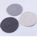 Three round cotton cord coasters in blue colour with modern simplicity design