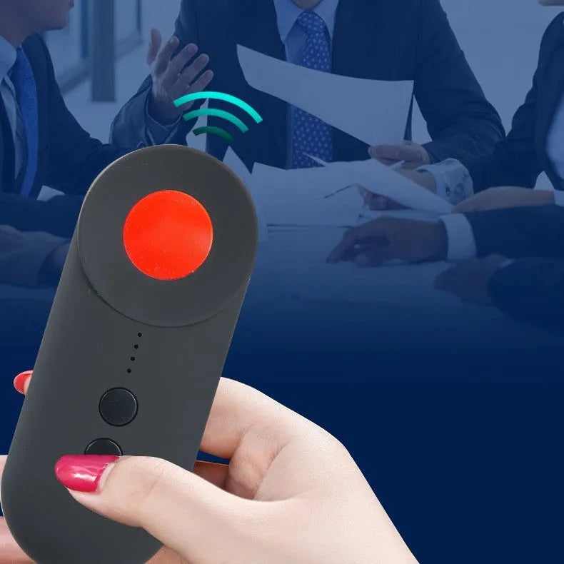 Black portable anti-car GPS and wifi signal detector with a USB cable on a table.
