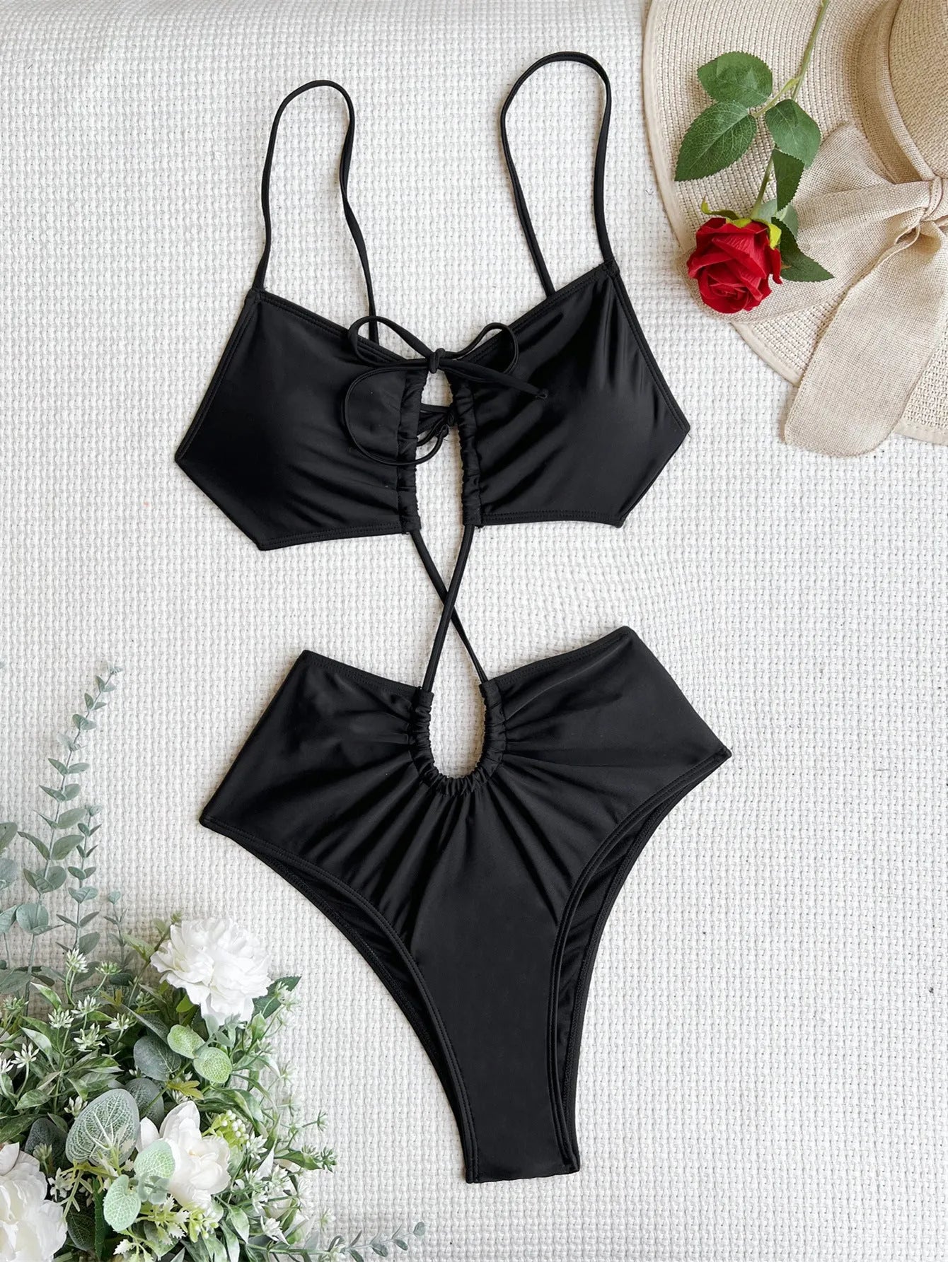 Women's black sleeveless one-piece swimsuit with hollow back triangle design