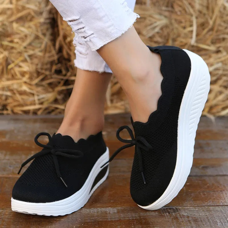 Women's fly-knit mesh sneakers in black with round toe and mid heel, fabric upper
