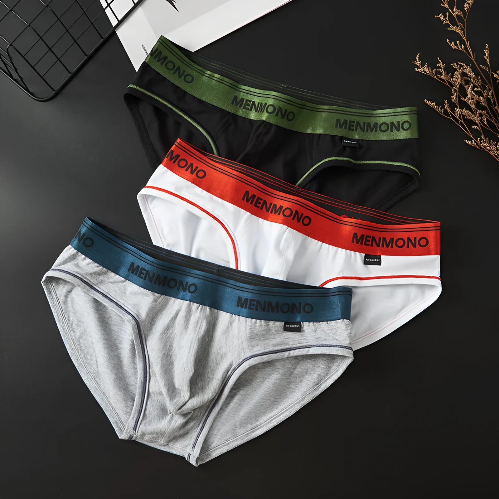 Men's low waist cotton briefs in a solid colour with contrast trim, shown in one of nine available colour combinations.