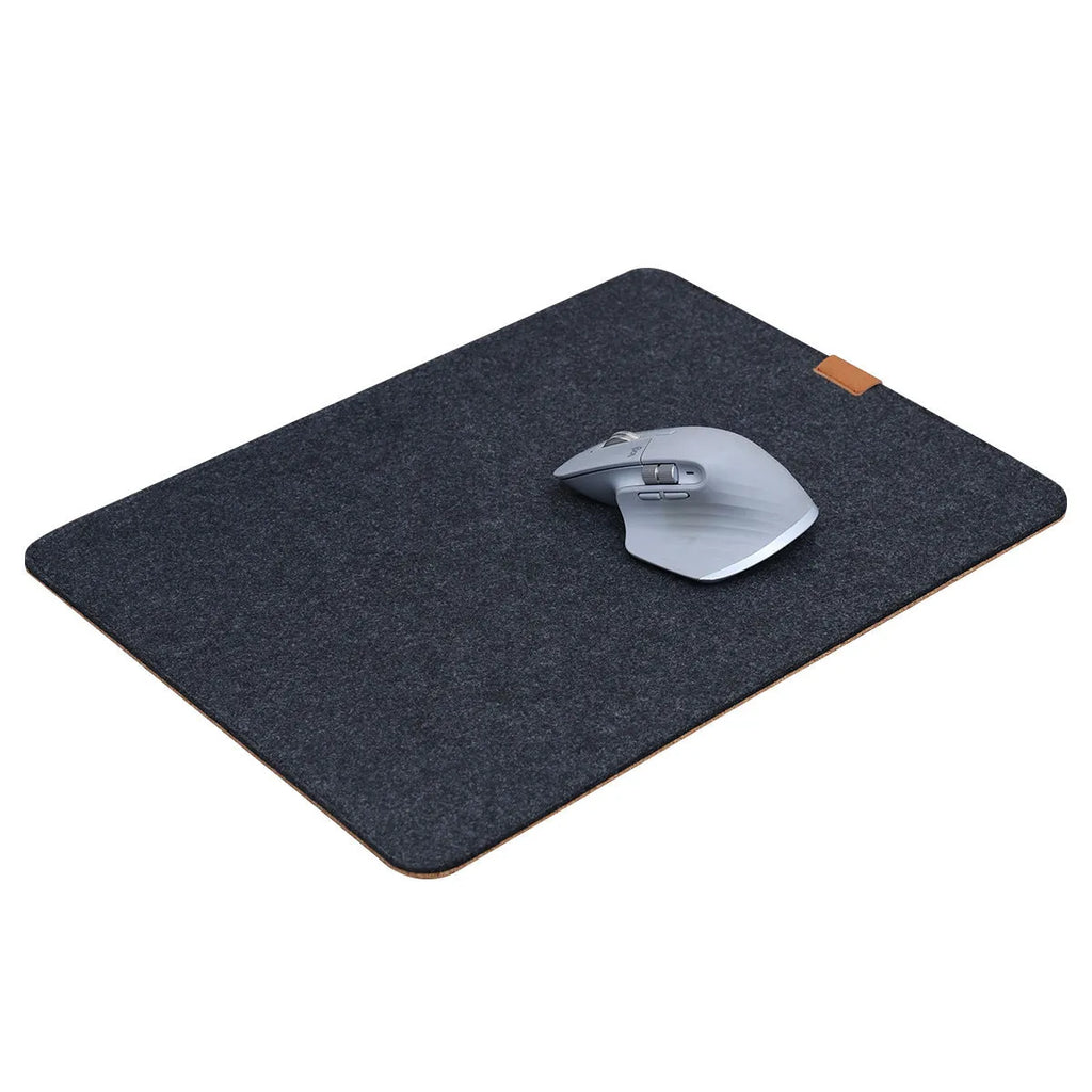 Oversized black and gray felt desk mat with cork base on a wooden desk