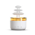 White Cloud Rain air humidifier and essential oil diffuser with colourful LED lights on a wooden table.