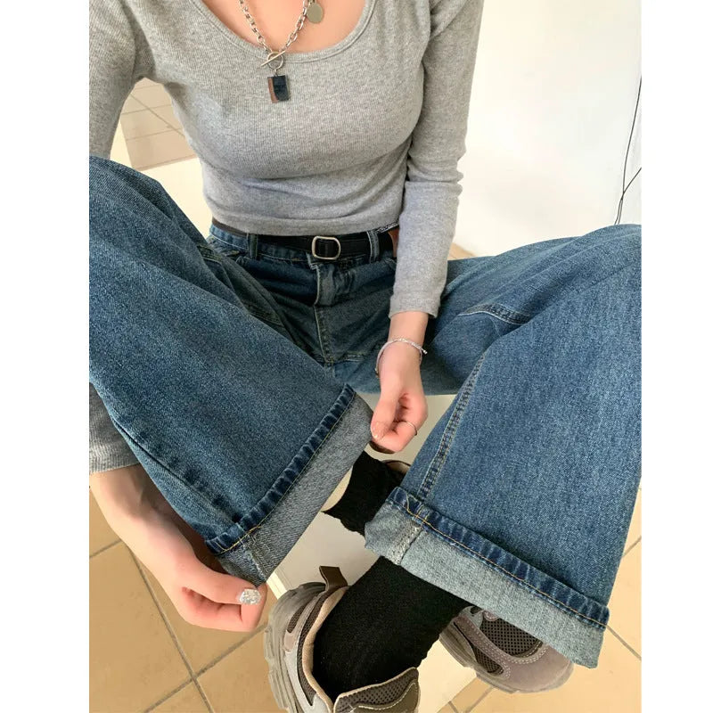 Women's retro blue straight-leg jeans with a high waist on a hanger.