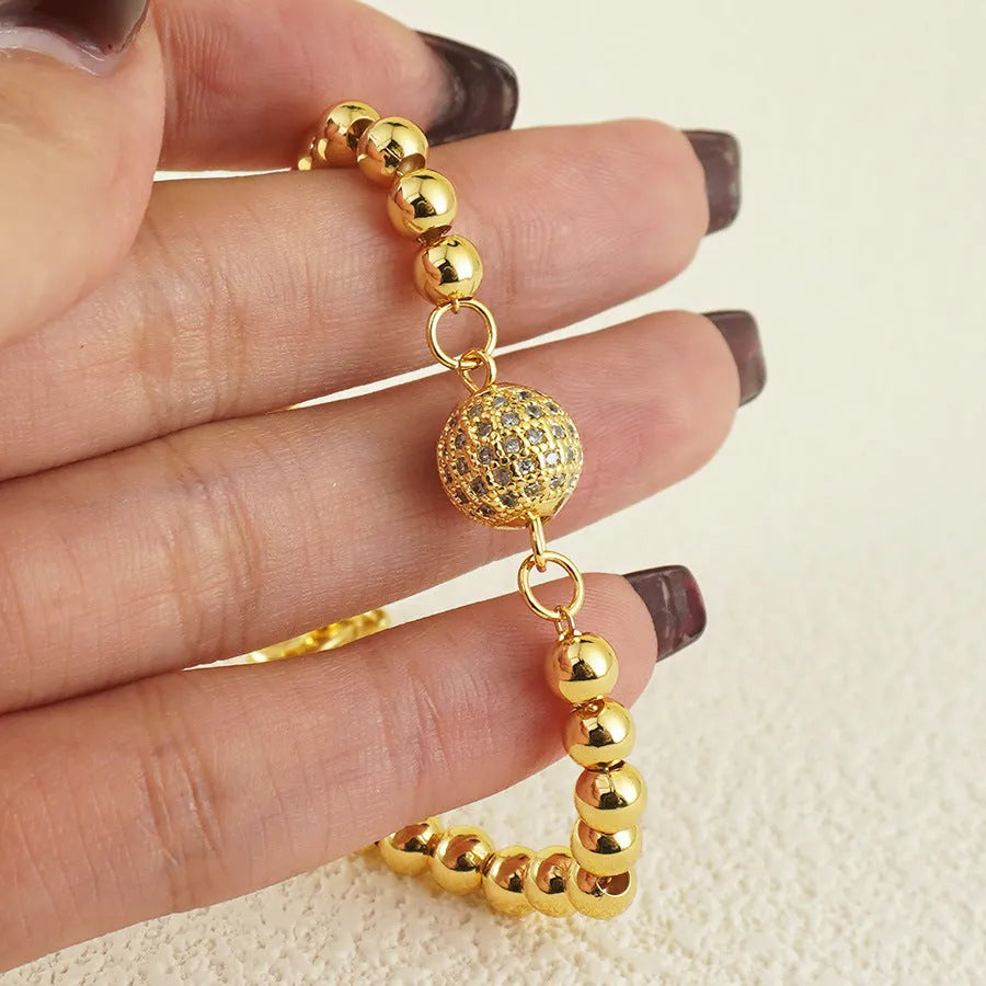 Close-up of a women's copper heart bracelet with a round zircon stone in an Arabic style.