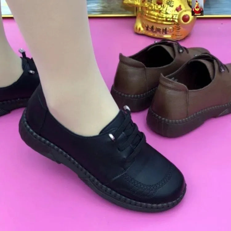 Women's soft leather low heel shoes in black with front lace-up and non-slip rubber sole