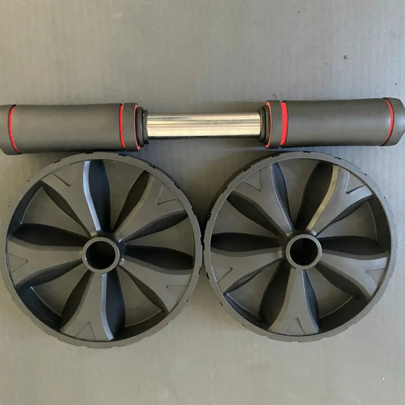 Black rebound abdominal roller with rubber wheel on a white background