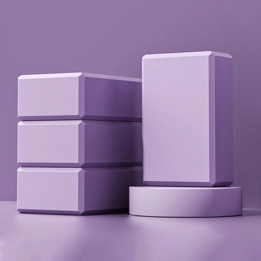Blue high-density EVA foam yoga block with ridged hexagonal sides on a gym mat.