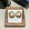 Set of three fashionable versatile earrings in silver gold and rose gold finishes on a light background