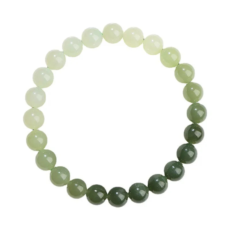 Natural clear water Hetian jade bracelet with round beads and barrel bead options on a wrist.