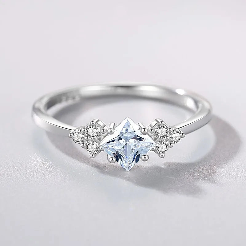 S925 silver ring with geometric rhombus shape and gold-plated setting on a plain background