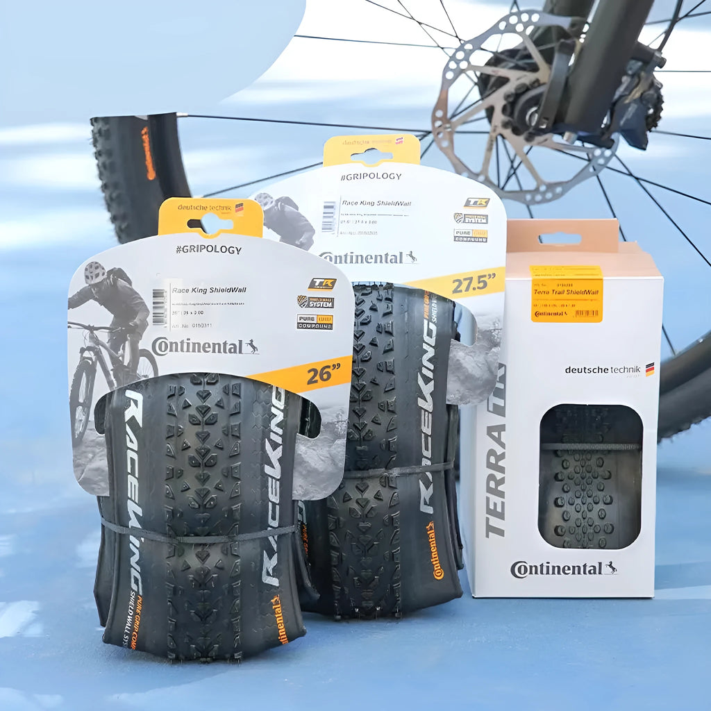 Mountain bike folding tyre shown in yellow and white, next to size options 26, 27.5 and 29 inches.