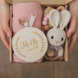 Baby teething gift set with bamboo gauze blanket, wooden chewing ring, woven bell, and developmental toys