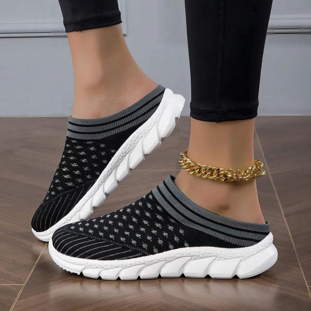 Women's Flyknit slipper shoes in a stripe pattern, showing hollowed-out design and sewing lines, on a viscose sole.