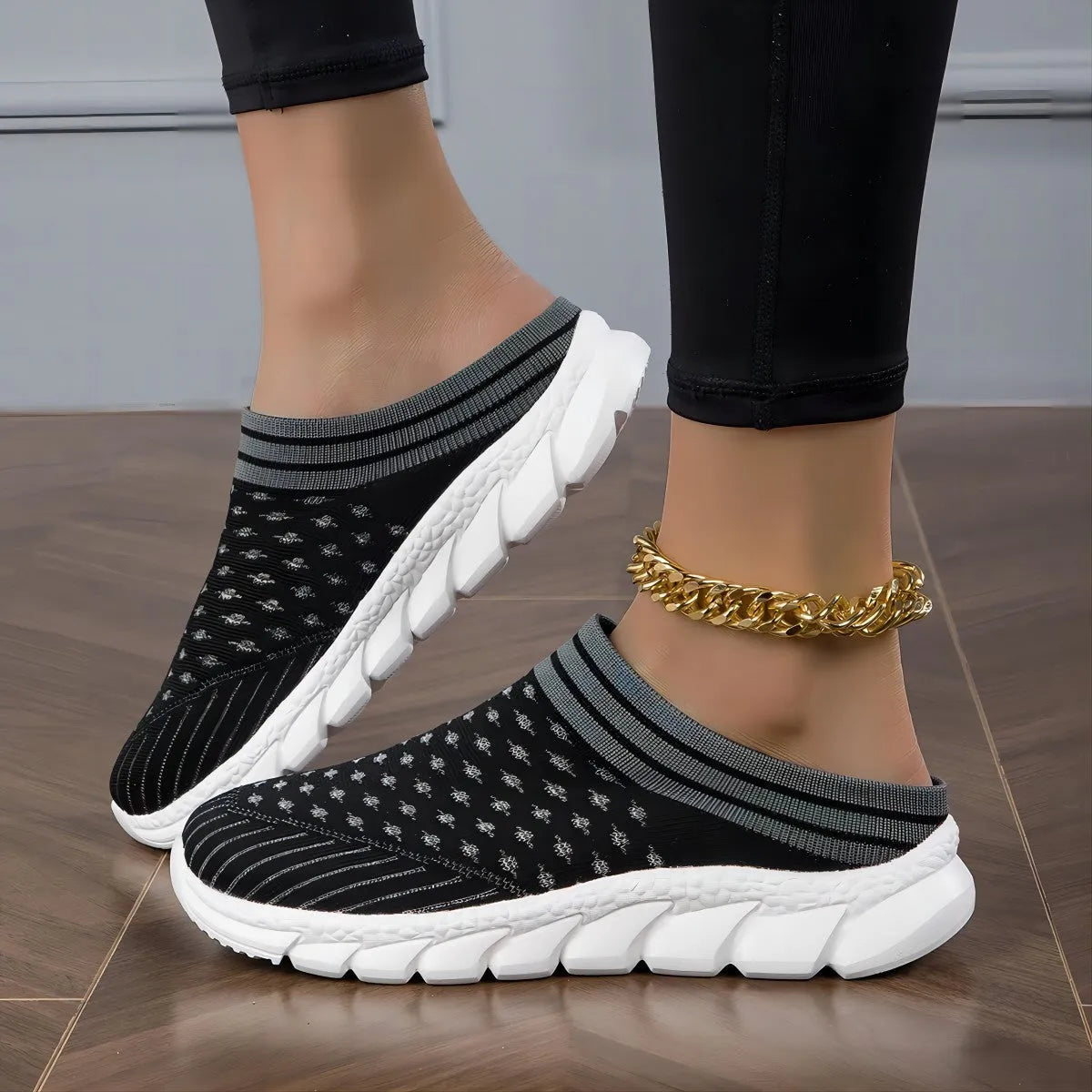 Women's Flyknit slipper shoes in a stripe pattern, showing hollowed-out design and sewing lines, on a viscose sole.