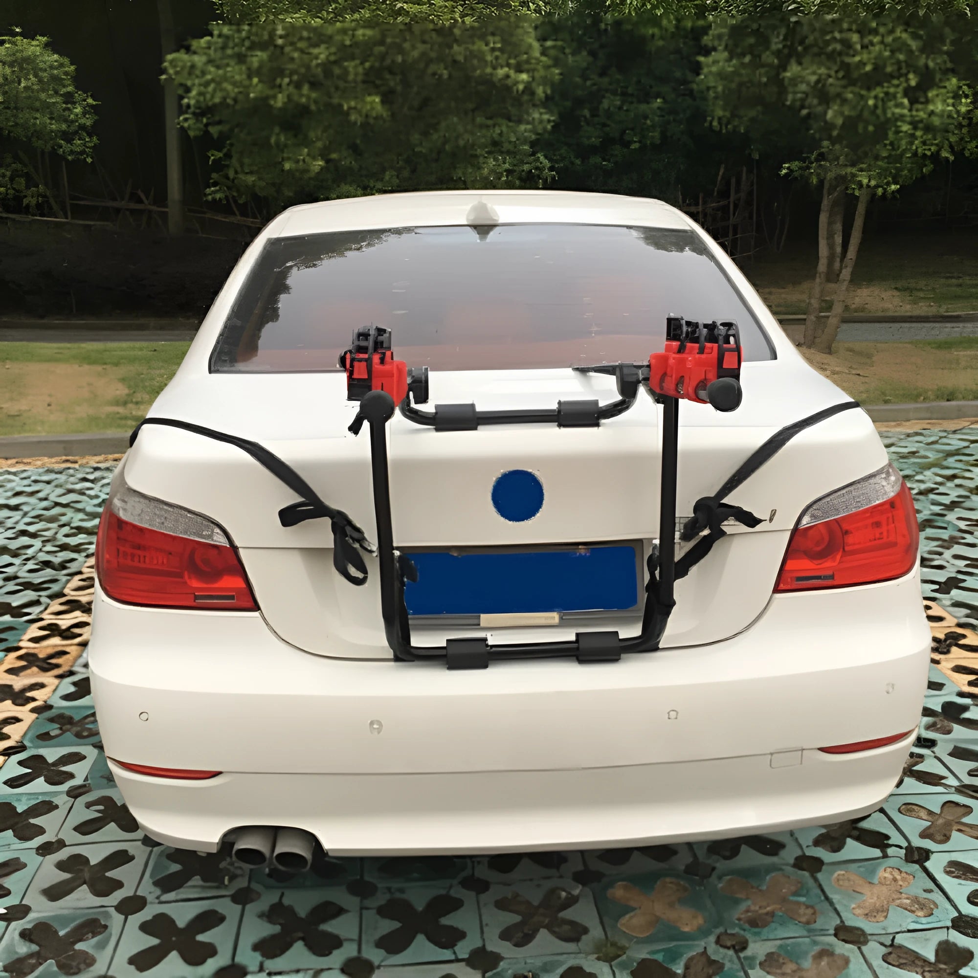 Black and red iron frame bike rack with straps for car boot mounting.