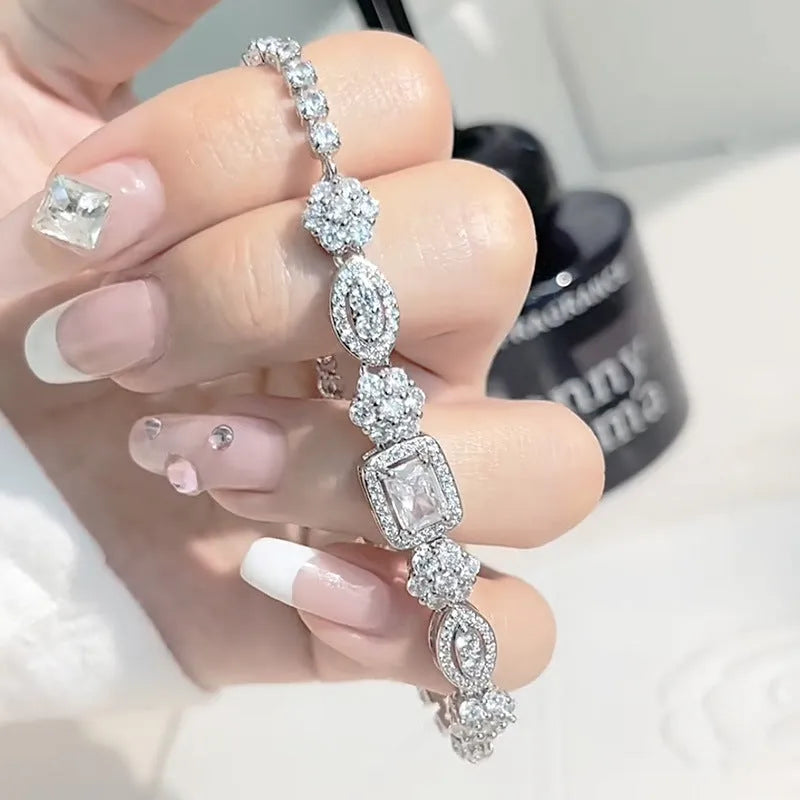 Women's geometric silver bracelet with adjustable chain and sparkling zircon stone on a wrist.