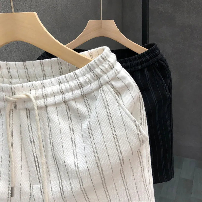 Men's black and white striped fleece-lined casual shorts with an elasticated waistband.