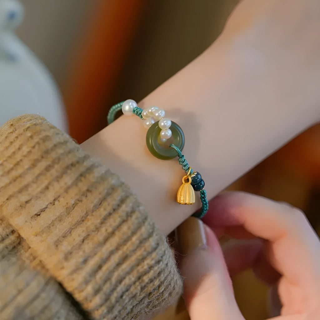 Hand-woven women's watch band with pearl details and a peace buckle in a retro style.
