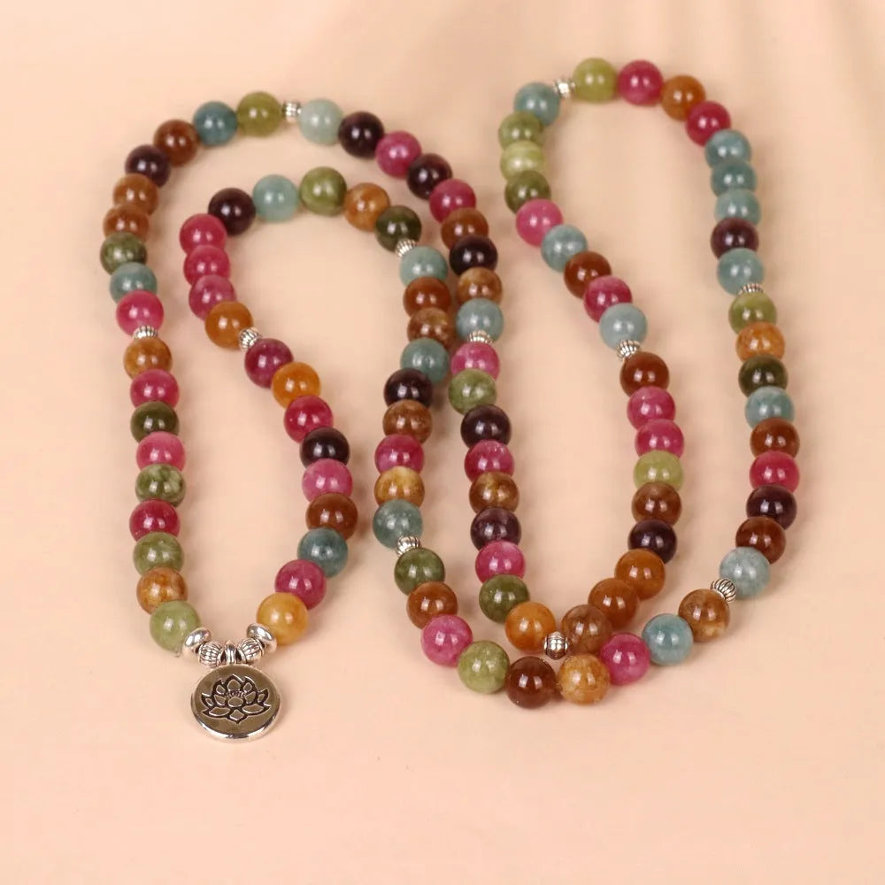 108 bead multi-strand bracelet with natural tourmaline stones and alloy clasp on a wrist.