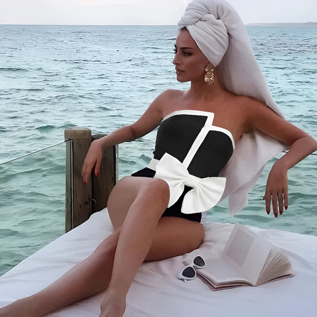 Women's black and white colour-blocking swimsuit with asymmetrical bow detail and tube top design