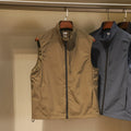 Men's thin nylon bandage-style vest in army green with side seam pockets on a hanger.