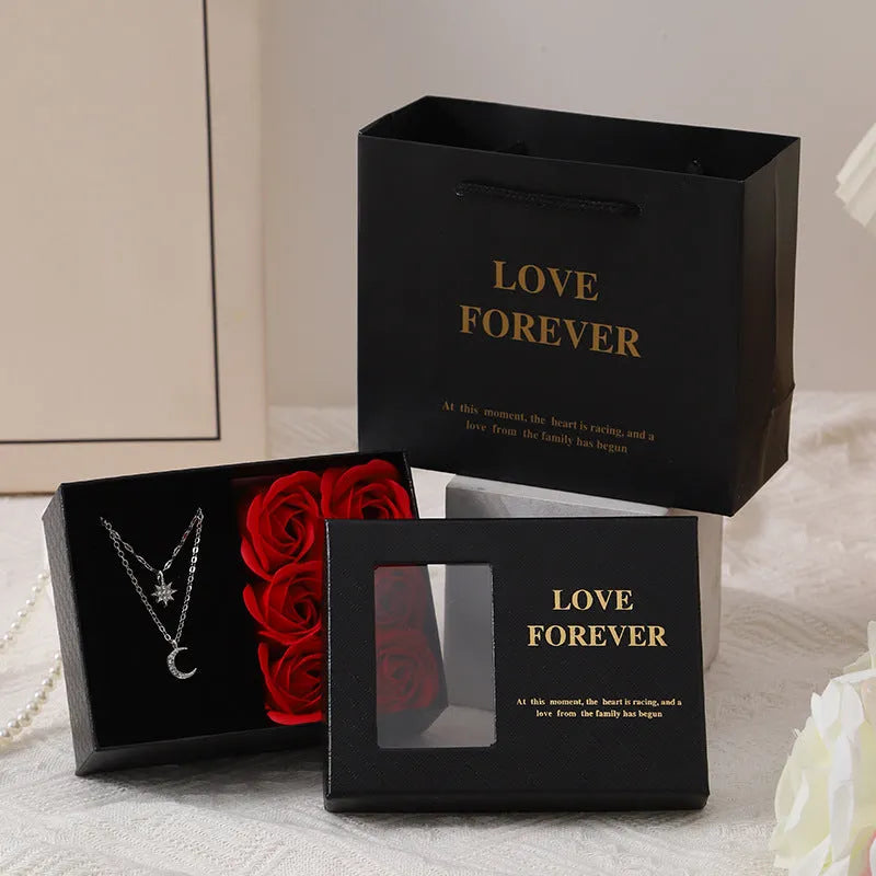 Six red soap roses in a black Korean-style gift box with a matching handbag