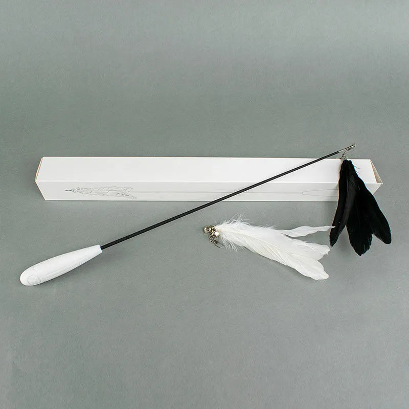 White telescopic fishing rod cat toy extended, with goose feather attachments and a small bell, on a neutral background.