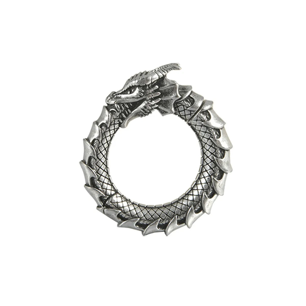 Pair of large antique silver dragon-shaped earrings with geometric hollow-out design on a white background.