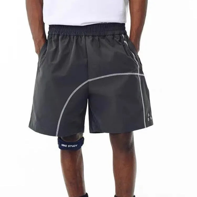 Retro drawstring shorts in polyester fabric showing dark grey, white and apricot colour options