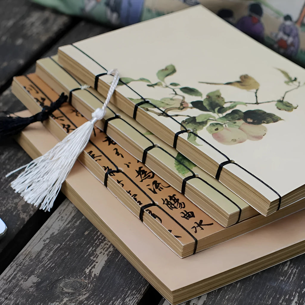 A5 antique wire-bound notebook with a retro famous painting cover on white cowhide, shown open on Kraft paper pages.
