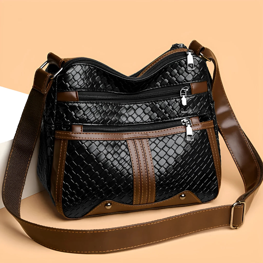 Woven PU messenger bag with single shoulder strap showing horizontal square shape and multiple compartments