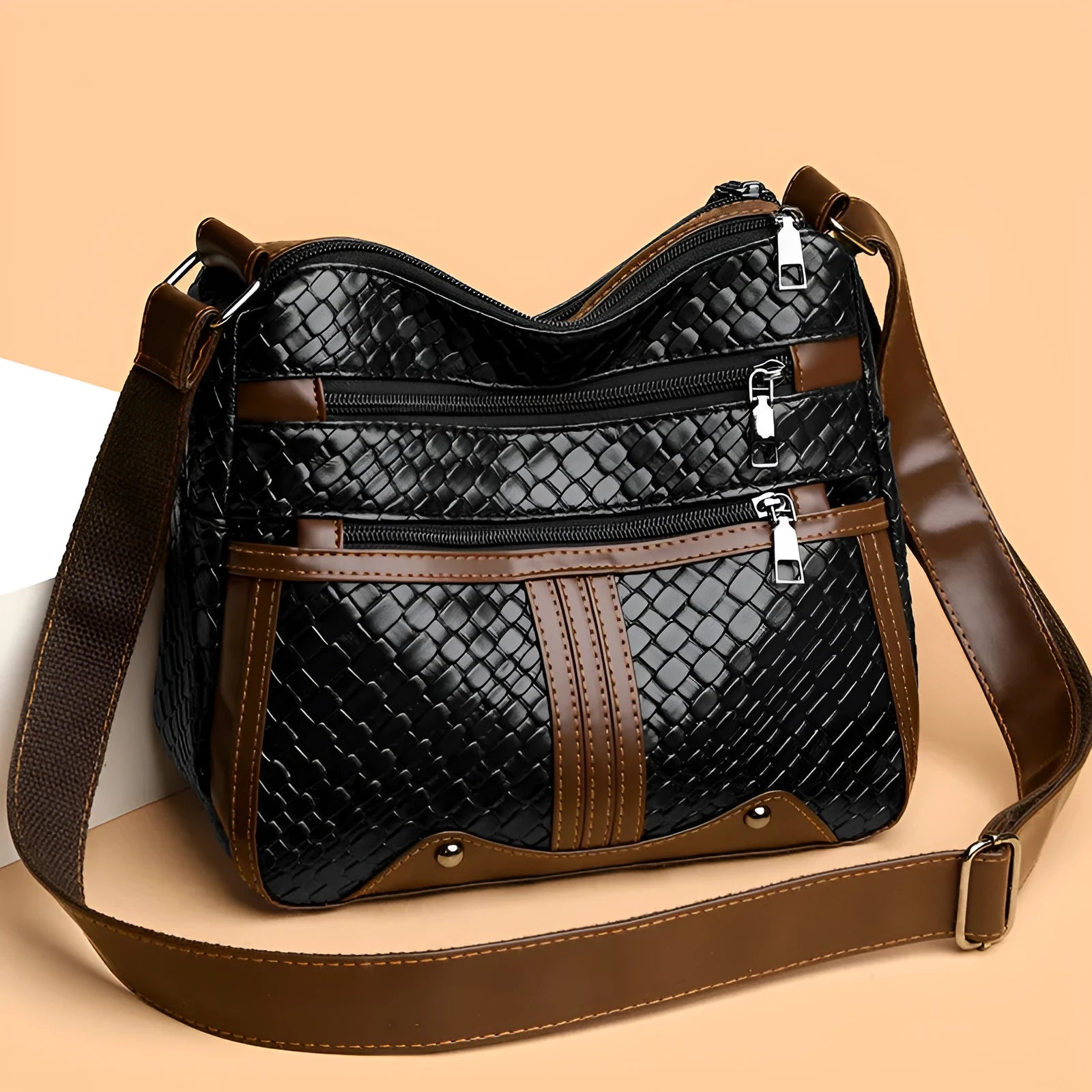 Woven PU messenger bag with single shoulder strap showing horizontal square shape and multiple compartments