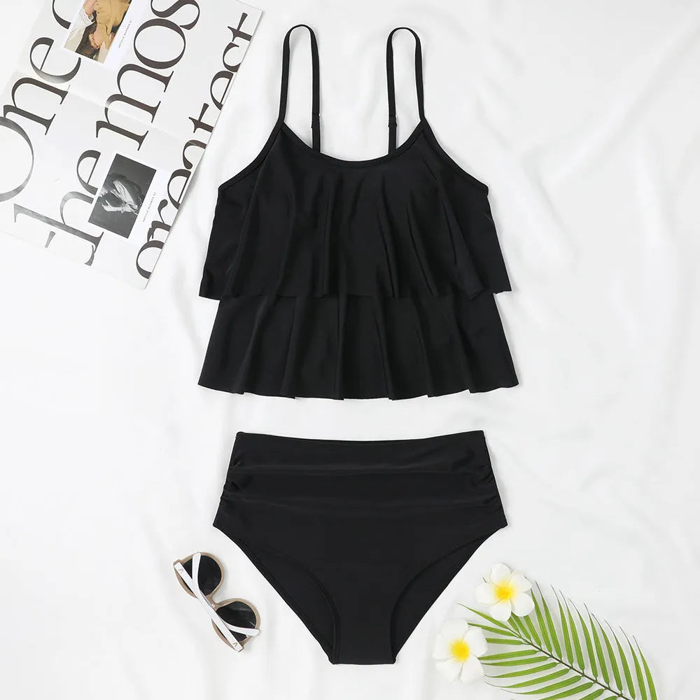 High waisted black floral print bikini with adjustable straps, shown on a model.