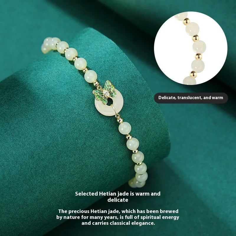 Cyan Hetian Jade bracelet with butterfly design and sterling silver accents, 6mm bead size