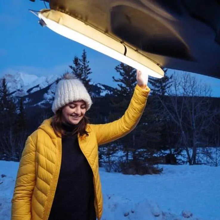 Portable inflatable folding USB LED lamp in army green, 65cm size, on a camping table.