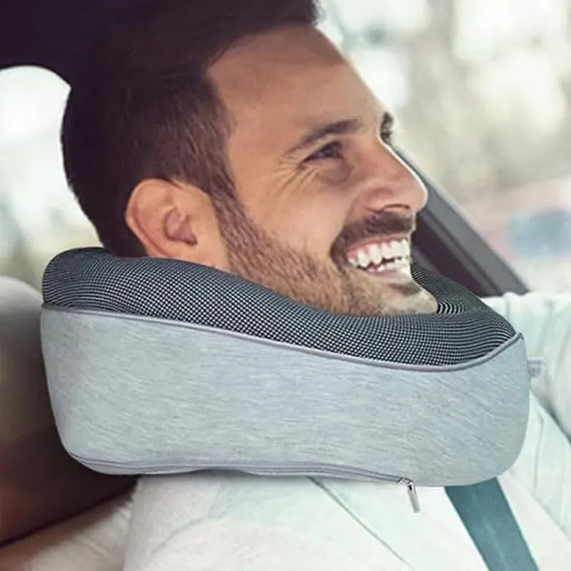 Navy blue memory foam U-shaped travel neck pillow rolled up next to its carry bag