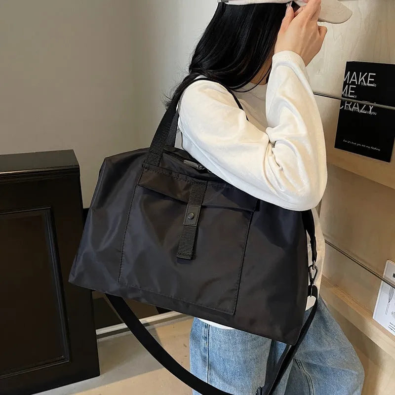 Grey one-shoulder travel backpack with 55 litre capacity showing Oxford cloth construction