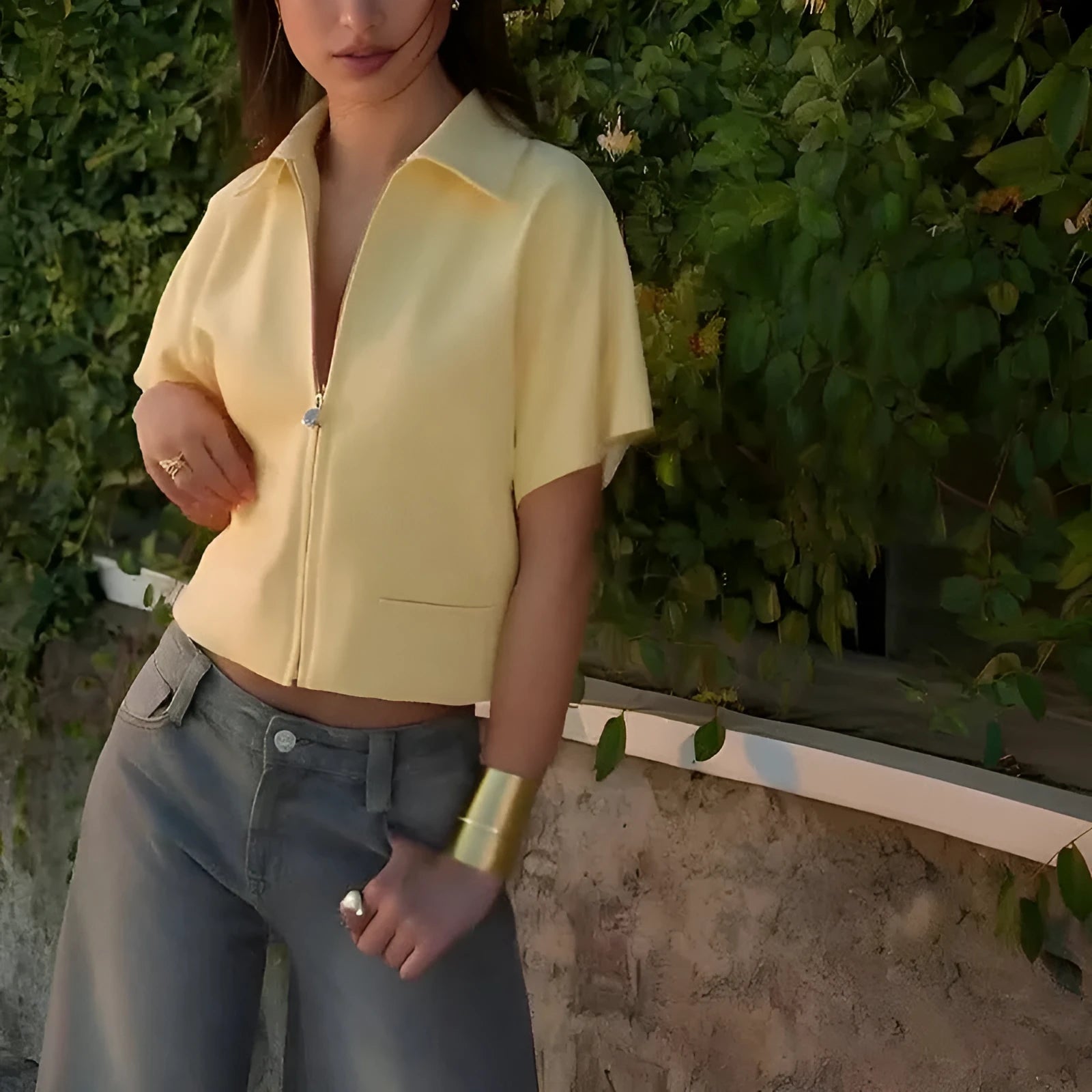 Model wearing a loose-fit short sleeve casual top in yellow damascus style.