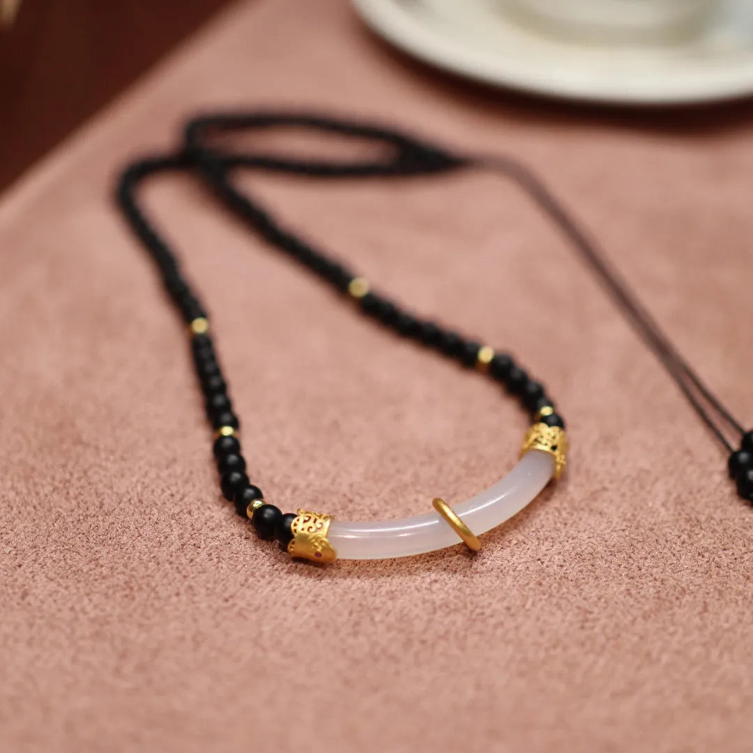 U-shaped Chinese style necklace with frosted black agate, white chalcedony, and 925 silver plating on a ball bead chain.