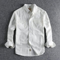 Men's light blue cotton long sleeve shirt in a cardigan style on a hanger